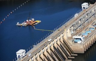Ludington dam located in Michigan on the Pere Marquette River. Barge in water with UCC crew for dam maintenance services.