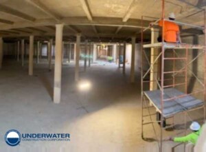 View of the interior of the concrete water tank with skilled UCC engineers devising a plan to fix severe leakage.