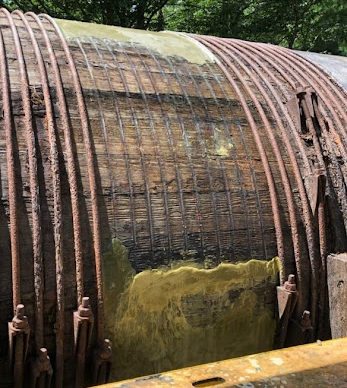 Removing steel banding from wood stave penstock