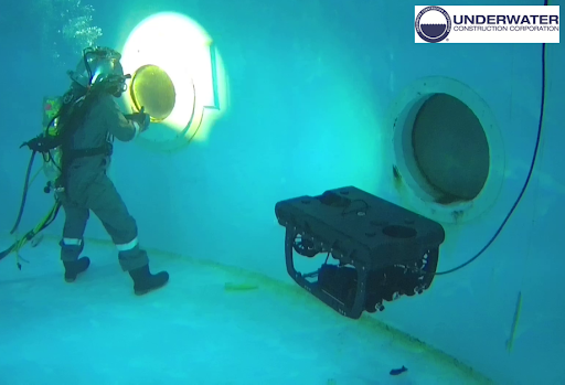 rov dive UCC commercial diver performing underwater inspection with remotely operated vehicle. UCC logo.